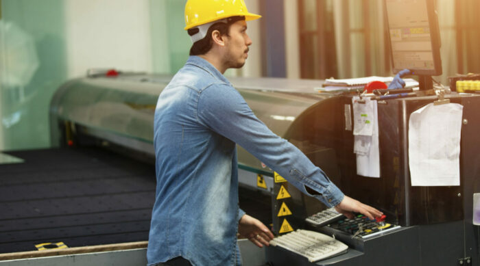 Hardhat worker operating a machine