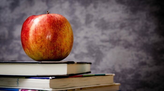 apple sitting on school books