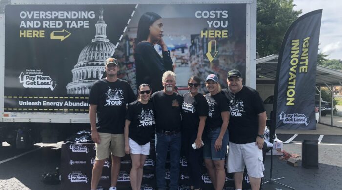 Americans for Prosperity-Pennsylvania activists stand in front of the True Cost of Washington Tour truck, which reads, 