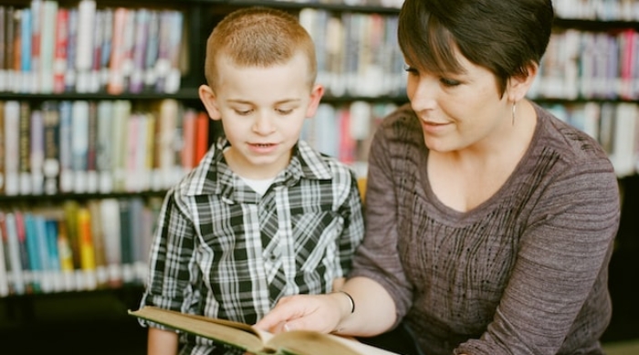 Governor Stitt's executive order bringing Oklahoma into compliance with the Supreme Court's ruling in Janus v. AFSCME strengthens the rights of Oklahoma educators. Here, a teacher reads with a student in the school library.